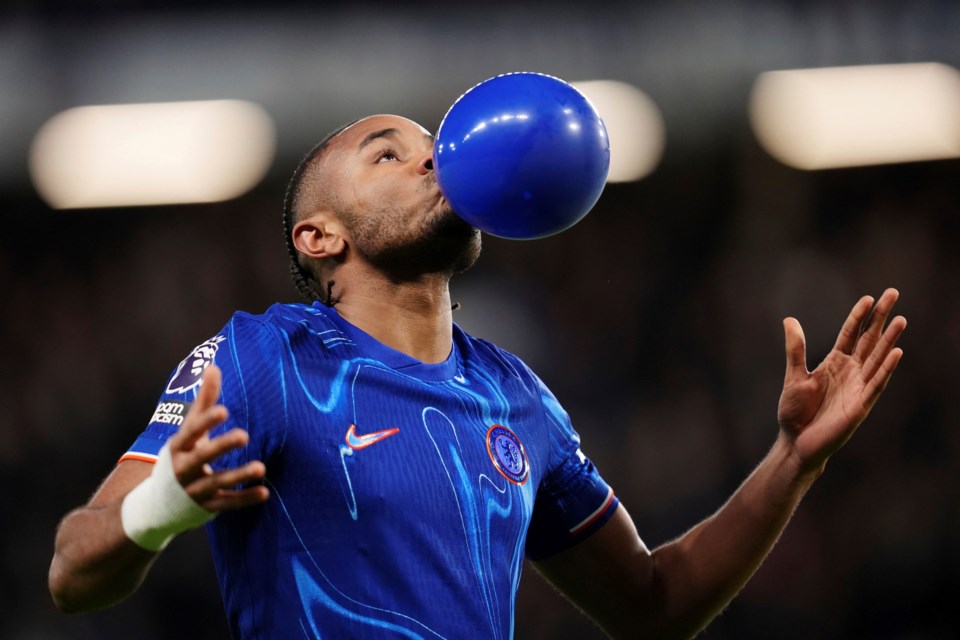 Chelsea's Christopher Nkunku celebrates scoring their side's first goal of the game during the English Premier League soccer match between Chelsea and Southampton at Stamford Bridge, London, Tuesday, Feb. 25, 2025. (John Walton/PA via AP)