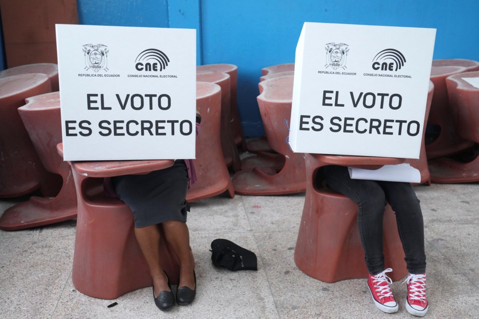 Voters mark ballots for their candidate of choice during the presidential election in Quito, Ecuador, Sunday, Feb. 9, 2025. (AP Photo/Dolores Ochoa)