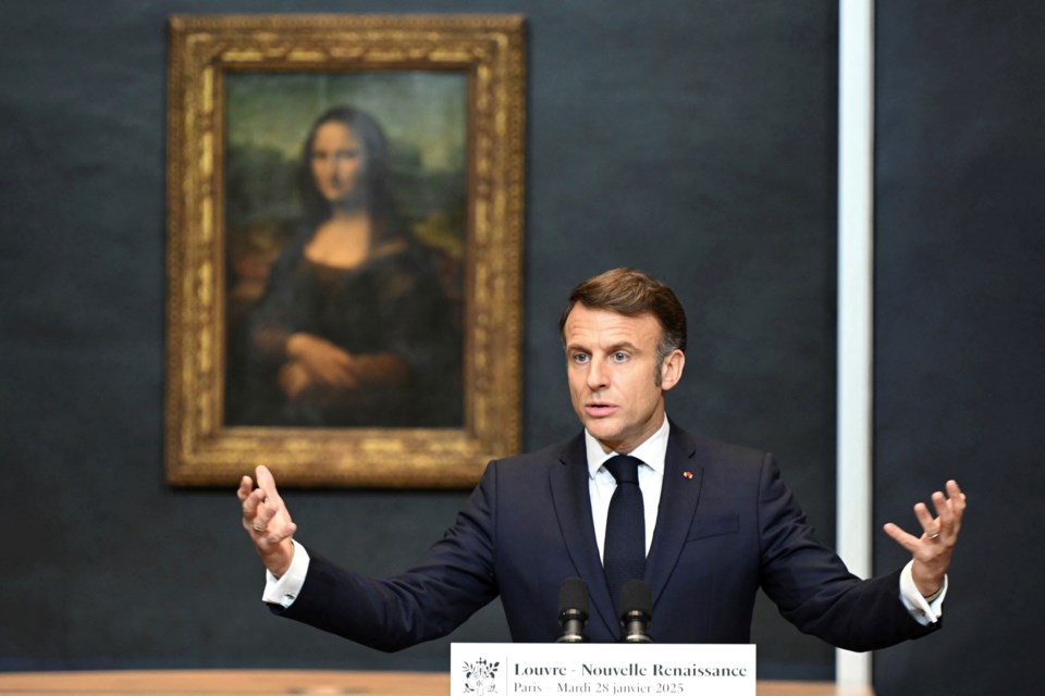 French President Emmanuel Macron gives a speech to announce a multi-year overhaul, long-term investments to modernize the Louvre museum, next to Leonardo da Vinci's painting of the Mona Lisa, at the Louvre Museum, Tuesday, Jan. 28, 2025 in Paris. ( Bertrand Guay, Pool via AP)