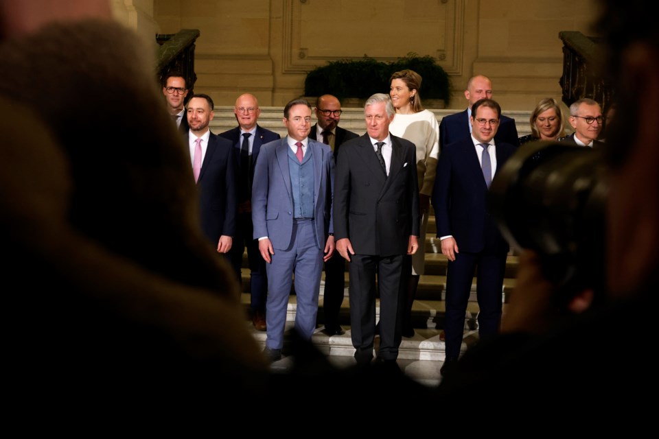 Belgium's King Philippe, center front, and new Belgian Prime Minister Bart De Wever, front center left, pose with ministers after a swearing in ceremony for the new government at the Royal Palace in Brussels, Monday, Feb. 3, 2025. (AP Photo/Omar Havana)