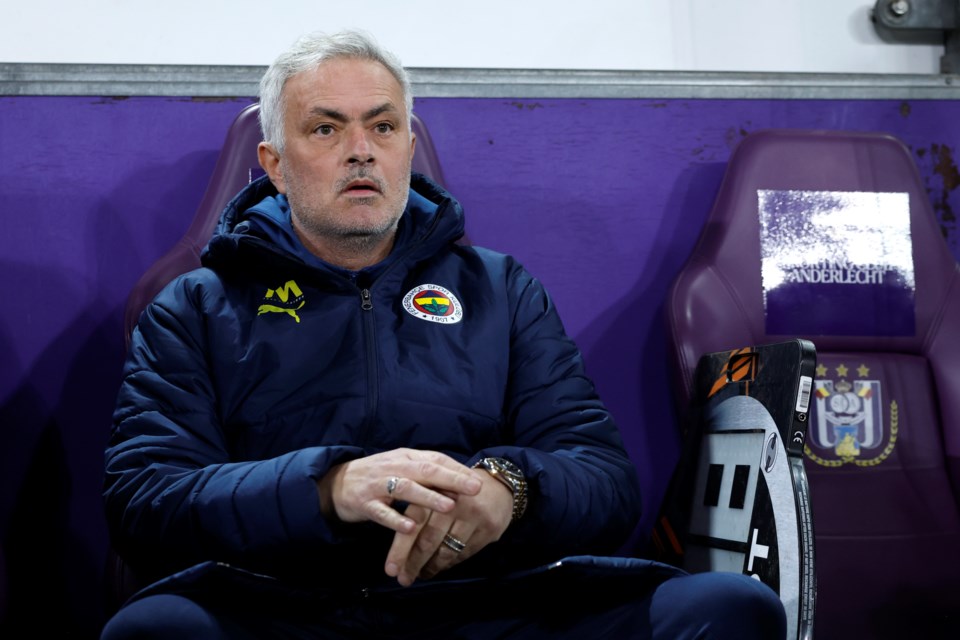 Fenerbahce's head coach Jose Mourinho, left, during the Europa League playoff second leg soccer match between Anderlecht and Fenerbahce at the RSC Anderlecht stadium in Brussels, Thursday, Feb. 20, 2025. (AP Photo/Omar Havana)