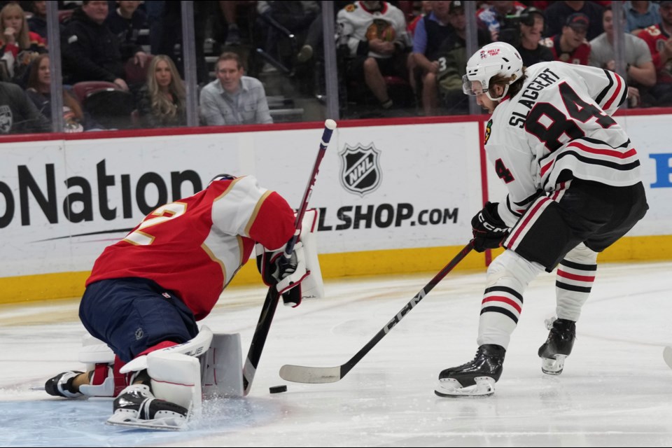 Chicago Blackhawks left wing Landon Slaggert (84) scores a goal against Florida Panthers goaltender Sergei Bobrovsky (72) during the first period of an NHL hockey game, Saturday, Feb. 1, 2025, in Sunrise, Fla. (AP Photo/Lynne Sladky)