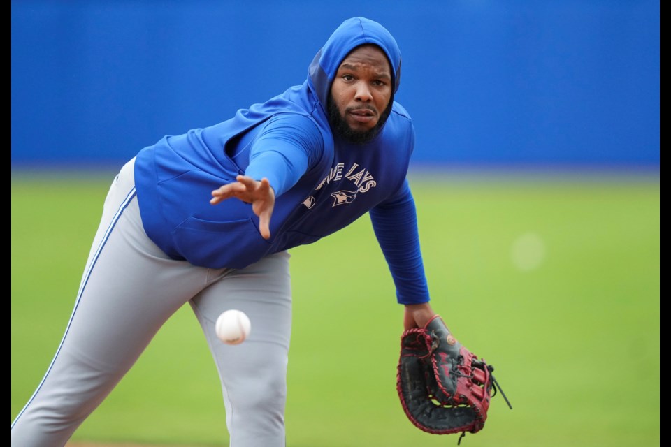 Toronto Blue Jays first baseman Vladimir Guerrero Jr. throws the ball to first base during spring training baseball workouts in Dunedin Fla., Thursday, Feb. 20, 2025. (Nathan Denette/The Canadian Press via AP)