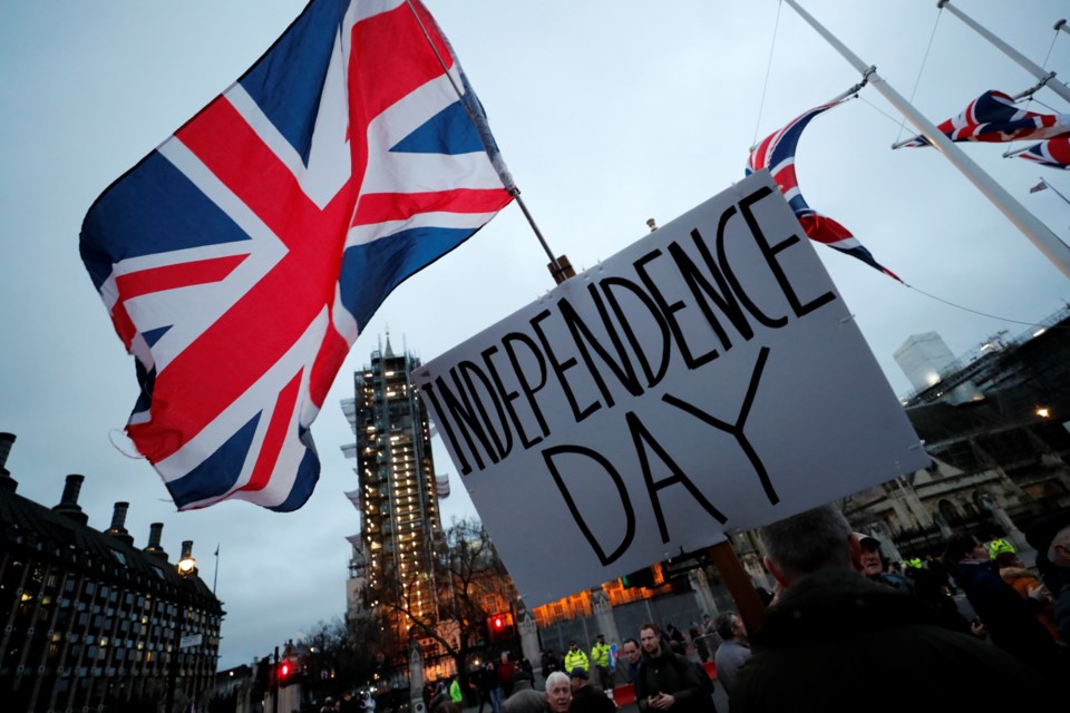 FILE - Brexit supporters gather during a rally in London, Friday, Jan. 31, 2020. Britain officially leaves the European Union on Friday after a debilitating political period that has bitterly divided the nation since the 2016 Brexit referendum. (AP Photo/Frank Augstein, File)