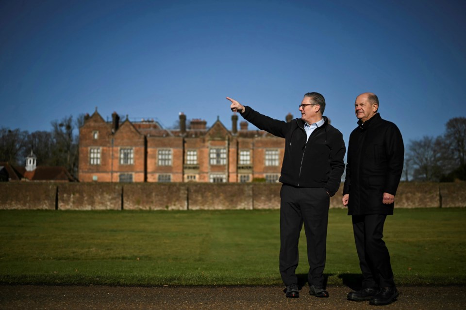 Britain's Prime Minister Keir Starmer, left, speaks with Germany's Chancellor Olaf Scholz as they have a walk in the garden of the Chequers, in Aylesbury, England, Sunday, Feb. 2, 2025. (Ben Stansall/Pool Photo via AP)