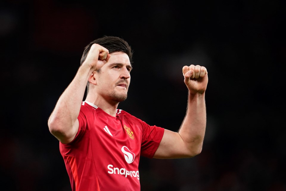 Manchester United's Harry Maguire celebrates after the English FA Cup fourth round soccer match between Manchester United and Leicester City at the Old Trafford stadium in Manchester, England, Friday, Feb. 7, 2025. (AP Photo/Dave Thompson)