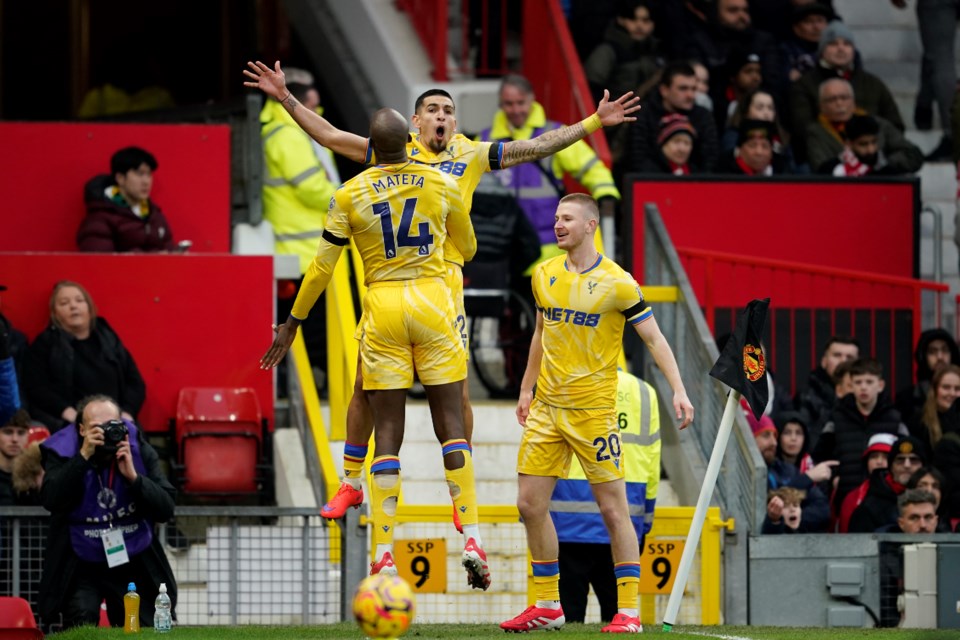 Crystal Palace's Jean-Philippe Mateta (14) celebrates with teammates after scoring his side's second goal during the English Premier League soccer match between Manchester United and Crystal Palace at Old Trafford stadium in Manchester, England, Sunday, Feb. 2, 2025. (AP Photo/Dave Thompson)