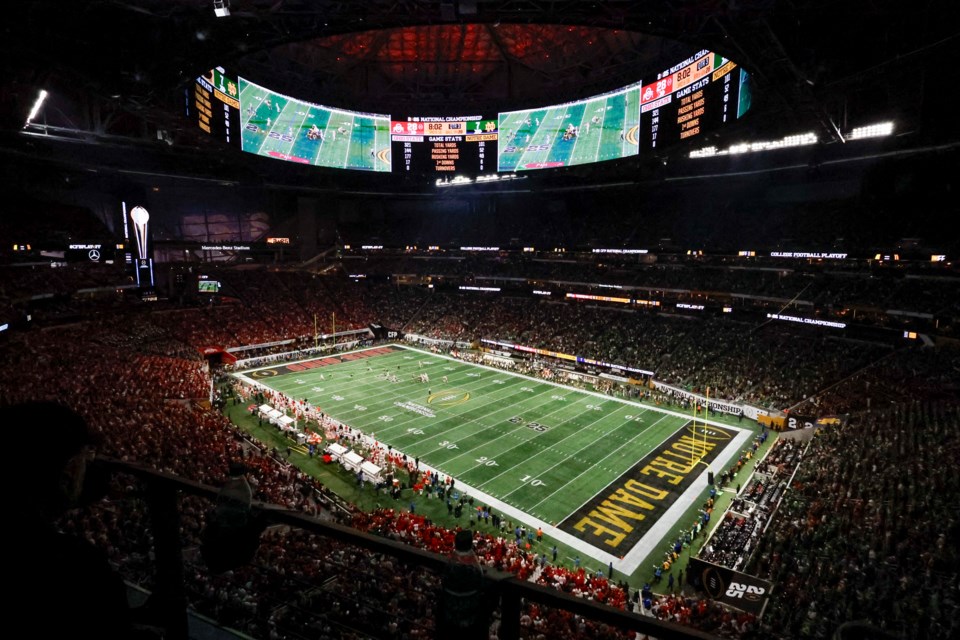 Fans watch during second half of the College Football Playoff national championship game between Ohio State and Notre Dame Monday, Jan. 20, 2025, in Atlanta. (AP Photo/Butch Dill)