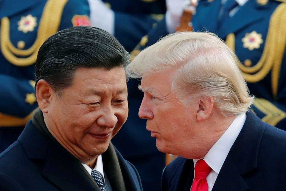 FILE - U.S. President Donald Trump, right, chats with Chinese President Xi Jinping during a welcome ceremony at the Great Hall of the People in Beijing on Nov. 9, 2017. (AP Photo/Andy Wong, File)