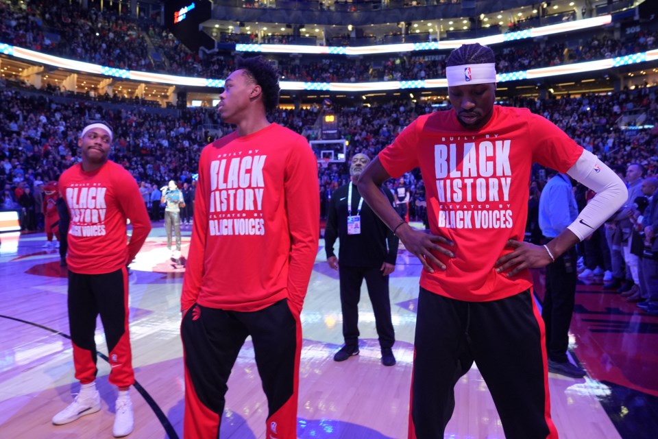 From left to right, Toronto Raptors forwards Bruce Brown, Scottie Barnes and Chris Boucher react as fans boo the United States national anthem before NBA basketball game action against the Los Angeles Clippers in Toronto, Sunday, Feb. 2, 2025. (Frank Gunn/The Canadian Press via AP)