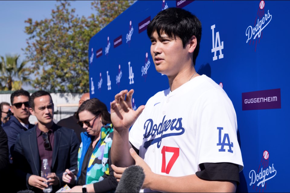 Los Angeles Dodgers' Shohei Ohtani talks to the media during a baseball interview during DodgerFest at Dodger Stadium, Saturday, Feb. 1, 2025, in Los Angeles. (AP Photo/Richard Vogel)