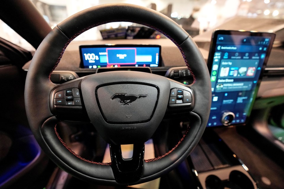 FILE - The cockpit of a Ford Mustang Mach-E electric car is pictured at the Motor Show in Essen, Germany, Dec. 2, 2021 (AP Photo/Martin Meissner, File)