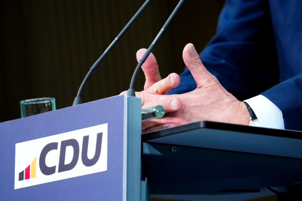 The hands of Friedrich Merz, leader of the Christian Democratic Union (CDU), as he speaks during a news conference at the headquarters of Christian Democratic Union (CDU) party in Berlin, Germany, Monday, Feb. 24, 2025. (AP Photo/Martin Meissner)