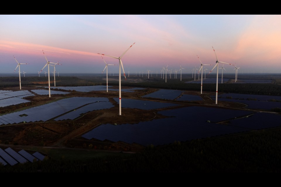 FILE - Wind turbines operate as the sun rises at the Klettwitz Nord solar energy park near Klettwitz near Klettwitz, Germany, Oct. 16, 2024. (AP Photo/Matthias Schrader, File)