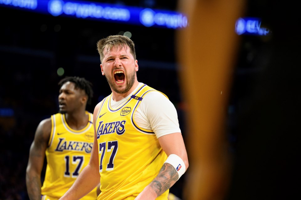 Los Angeles Lakers guard Luka Doncic (77) reacts after making a shot during the second half of an NBA basketball game against the Charlotte Hornets, Wednesday, Feb. 19, 2025, in Los Angeles. (AP Photo/William Liang)