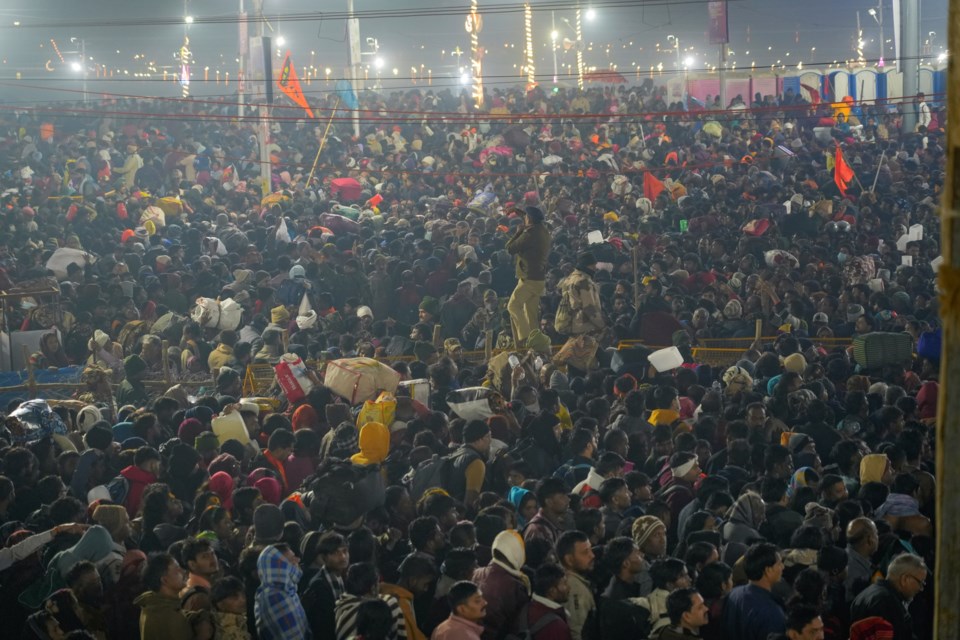 Hindu devotees gather for a holy dip by the banks of the Sangam, the confluence of the Ganges, the Yamuna and the mythical Saraswati rivers, on Mauni Amavasya' or new moon day during the Maha Kumbh festival in Prayagraj, Uttar Pradesh, India, Wednesay, Jan. 29, 2025. (AP Photo/Deepak Sharma)