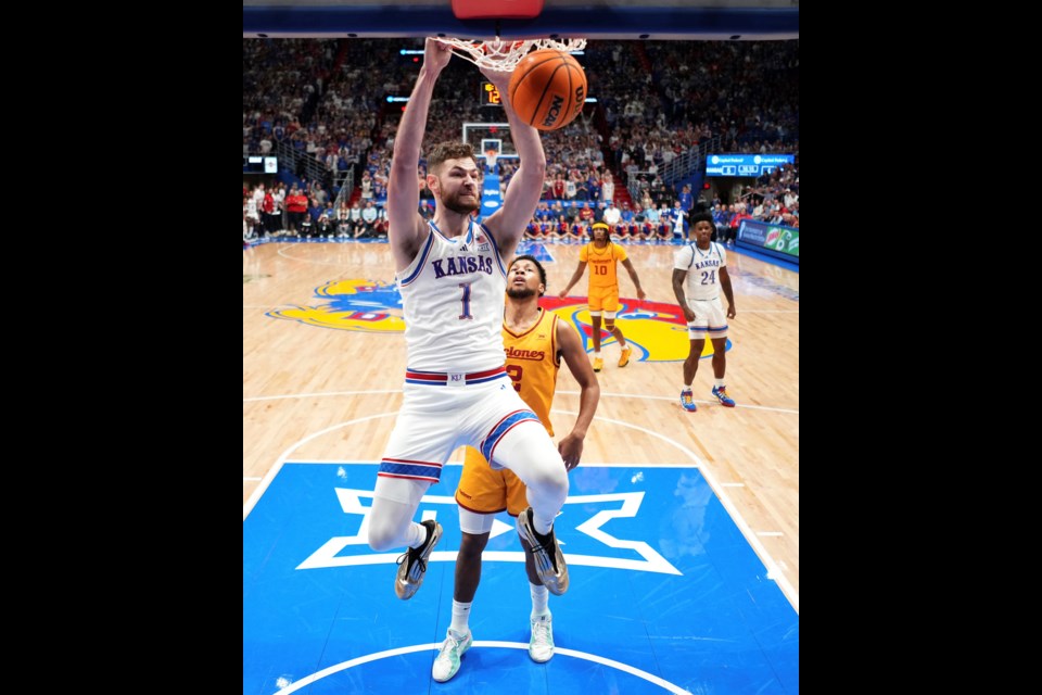 Kansas center Hunter Dickinson (1) dunks the ball during the first half of an NCAA college basketball game against Iowa State, Monday, Feb. 3, 2025, in Lawrence, Kan. (AP Photo/Charlie Riedel)