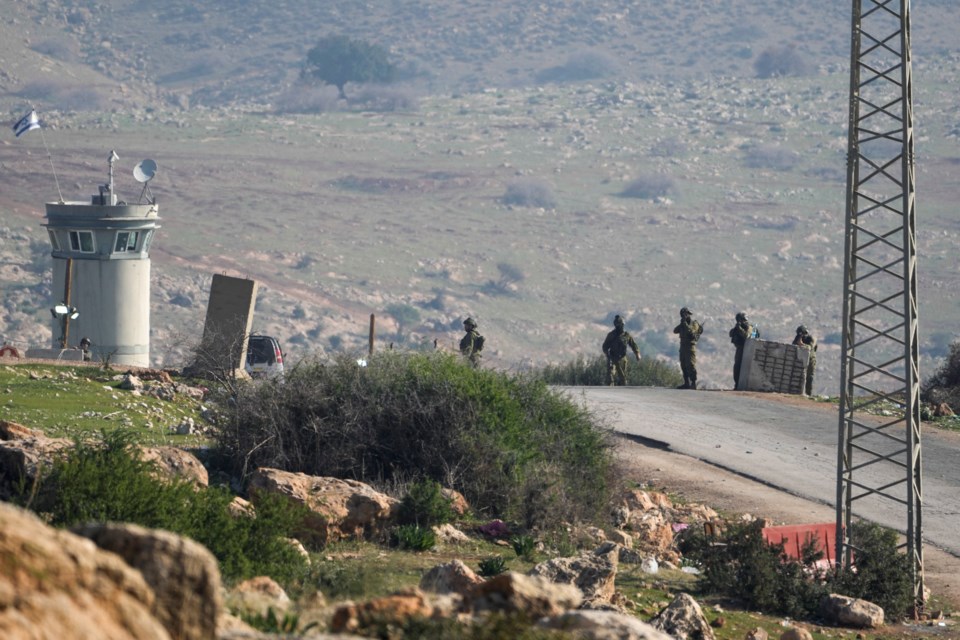 Israeli soldiers stand guard at a checkpoint where the military said an attacker fired at an army base near the village of Tayasir in the northern West Bank, Tuesday, Feb. 4, 2025. At least six soldiers were injured, and the attacker was killed by Israeli fire. (AP Photo/Majdi Mohammed)