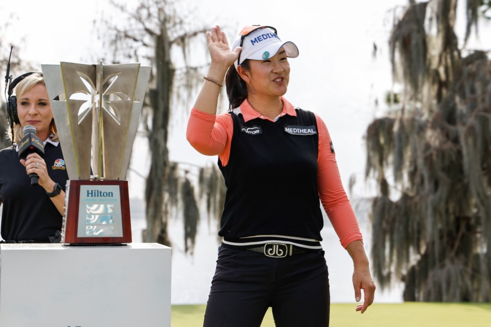 A Lim Kim, right, reacts to the crowd after being announced as the winner of the Hilton Grand Vacations Tournament of Champions LPGA golf tournament in Orlando, Fla., Sunday, Feb. 2, 2025. (AP Photo/Kevin Kolczynski)