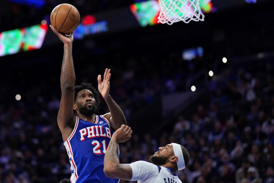 Philadelphia 76ers' Joel Embiid, left, goes up for a shot against Dallas Mavericks' Daniel Gafford during the second half of an NBA basketball game, Tuesday, Feb. 4, 2025, in Philadelphia. (AP Photo/Matt Slocum)