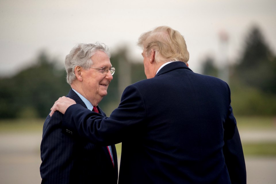 FILE - President Donald Trump speaks with Senate Majority Leader Mitch McConnell of Ky., left, as he arrives at Blue Grass Airport in Lexington, Ky., Oct. 13, 2018, to travel to Richmond, Ky., for a rally. (AP Photo/Andrew Harnik, File)