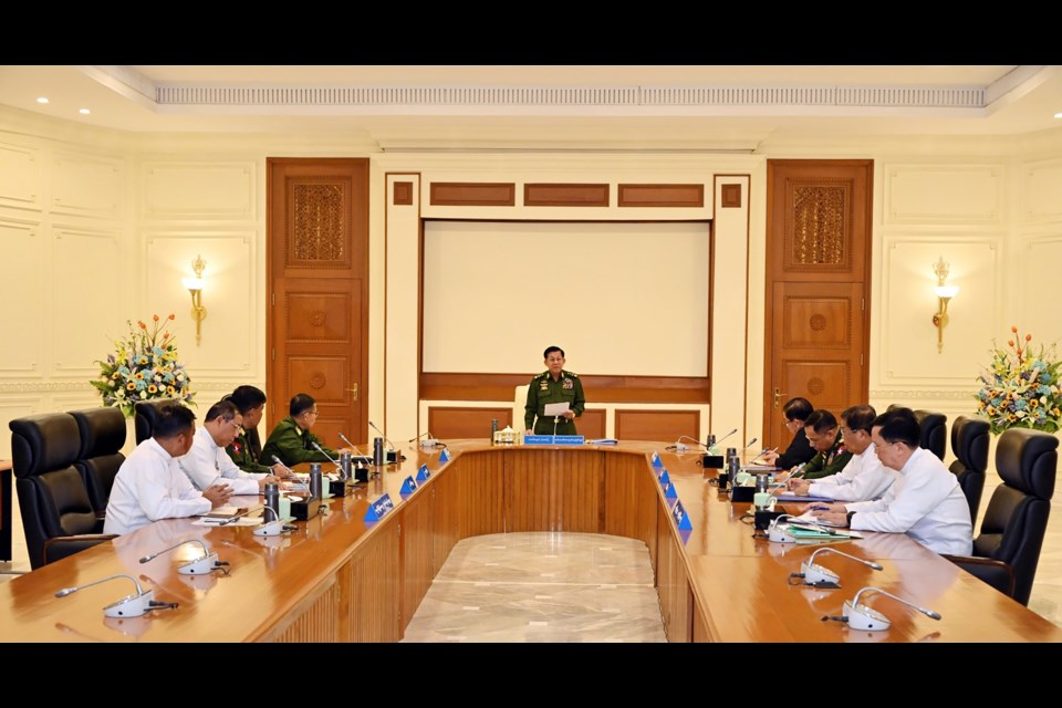 In this image provided by The Myanmar Military True News Information Team, Myanmar's military leader Senior Gen. Min Aung Hlaing, center, speaks during meeting with members of the National Defense and Security Council Friday, Jan. 31, 2025, in Naypyitaw, Myanmar.(The Myanmar Military True News Information Team via AP)