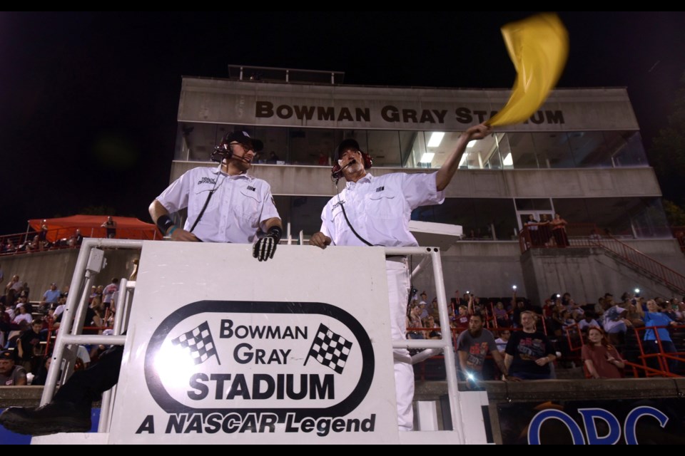 FILE - Flagmen Matt Garrison, left, and Randy Smith prepare for their next race, Saturday, June 15, 2024 at Bowman Gray Stadium in Winston-Salem, N.C. (Walt Unks/Winston-Salem Journal via AP, File)