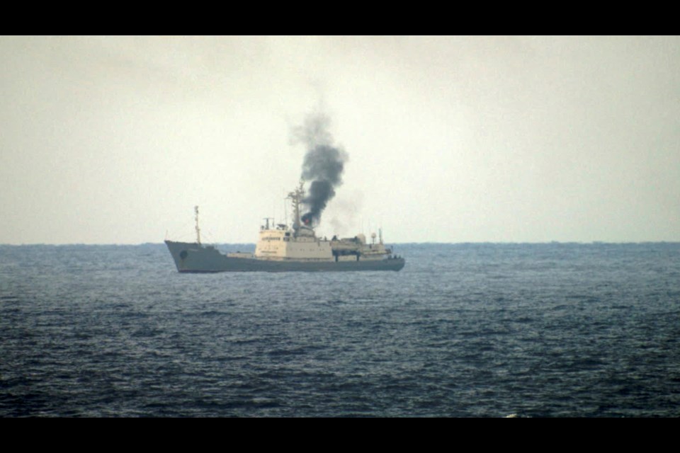 Military officials say this photo taken from a nearby vessel shows smoke rising from a fire aboard the Russian spy ship Kildin off the coast of Syria on Jan. 23, 2025. (AP Photo)