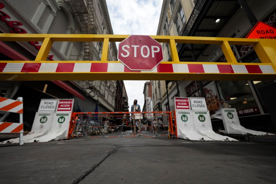 Newly installed security barriers are seen on Bourbon Street next to a memorial for victims of the Jan. 1 car attack ahead of the Super Bowl in New Orleans, Friday, Jan. 31, 2025. (AP Photo/Gerald Herbert)