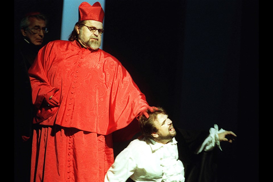 FILE - Paul Plishka as the Grand Inquisitor, left, and Sergei Larin as Don Carlo, perform in the opera "Don Carlo" by Giuseppe Verdi during a rehearsal at the Salzburg Festival’s Grosses Festpielhaus in Salzburg, Austria on Aug. 4, 1998. (AP Photo/Ronald Zak, File)