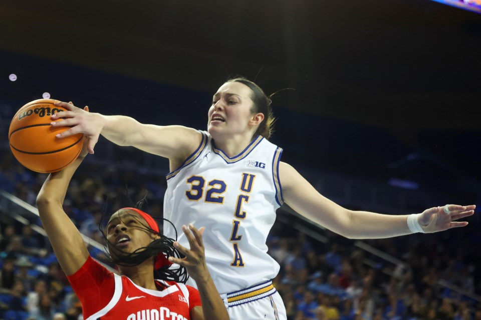 UCLA forward Angela Dugalic (32) blocks a shot by Ohio State guard Kennedy Cambridge during the first half of an NCAA college basketball game Wednesday, Feb. 5, 2025, in Los Angeles. (AP Photo/Jessie Alcheh)