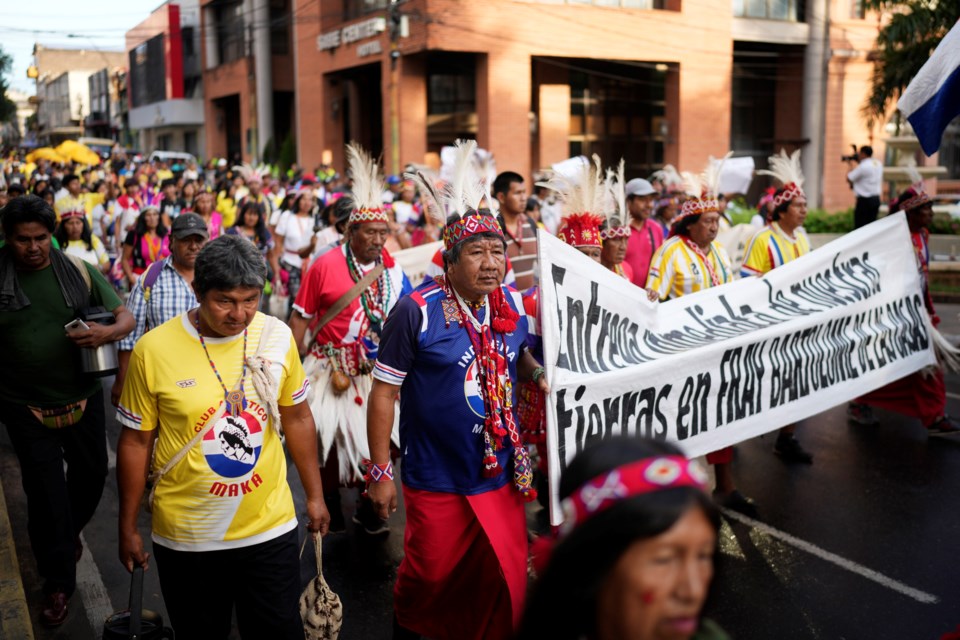 FILE - Maka Indigenous people march to protest for the recovery of ancestral lands in Asuncion, Paraguay, Feb. 28, 2024. (AP Photo/Jorge Saenz, File)