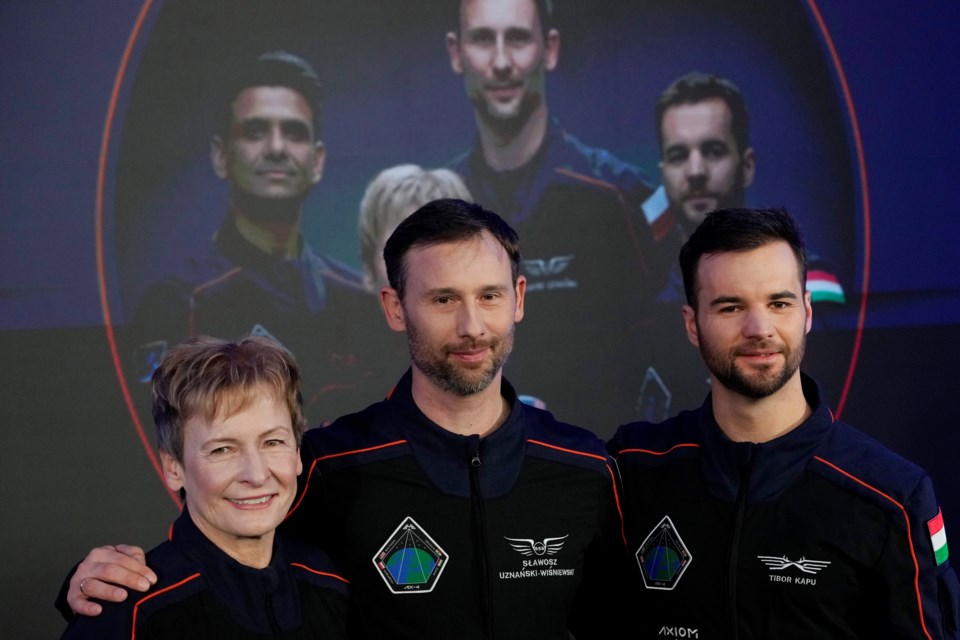 U.S. astronaut Peggy Whitson, left, commander of the Ax-4 scientific space mission, poses with crew members Slawosz Uznanski-Wisniewski of Poland, center, and Tibor Kapu of Hungary during a media event where they talked about their preparations, at the Copernicus Science Center in Warsaw, Poland, Wednesday, Feb. 5, 2025. (AP Photo/Czarek Sokolowski)