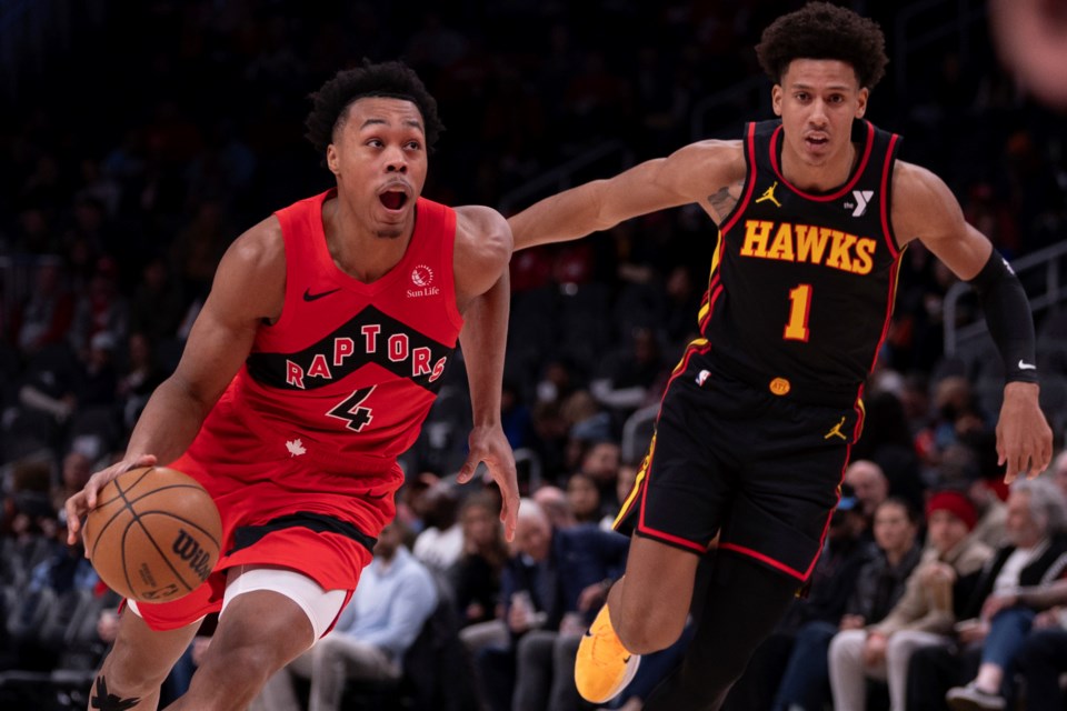 Toronto Raptors forward Scottie Barnes (4) dribbles the ball past Atlanta Hawks forward Jalen Johnson (1) during the first half of an NBA basketball game, Thursday, Jan. 23, 2025, in Atlanta. (AP Photo/Kathryn Skeean)