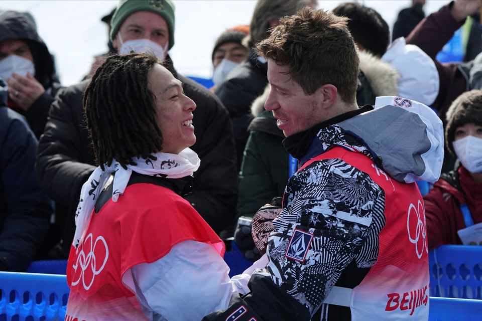 FILE - Gold medal winner Japan's Ayumu Hirano, left, is congratulated by United States' Shaun White after the men's halfpipe finals at the 2022 Winter Olympics, Feb. 11, 2022, in Zhangjiakou, China. (AP Photo/Gregory Bull, File)