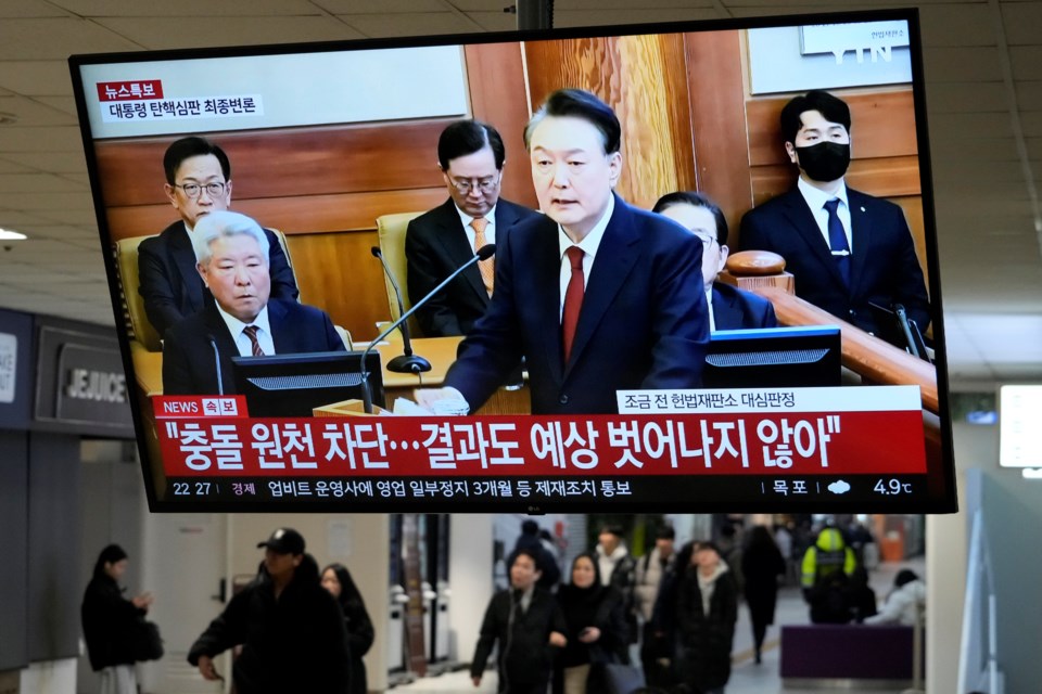 A TV screen shows footage of impeached South Korean President Yoon Suk Yeol's address at the final hearing of his trial during a news program at a bus terminal in Seoul, South Korea, Tuesday, Feb. 25, 2025. (AP Photo/Ahn Young-joo)