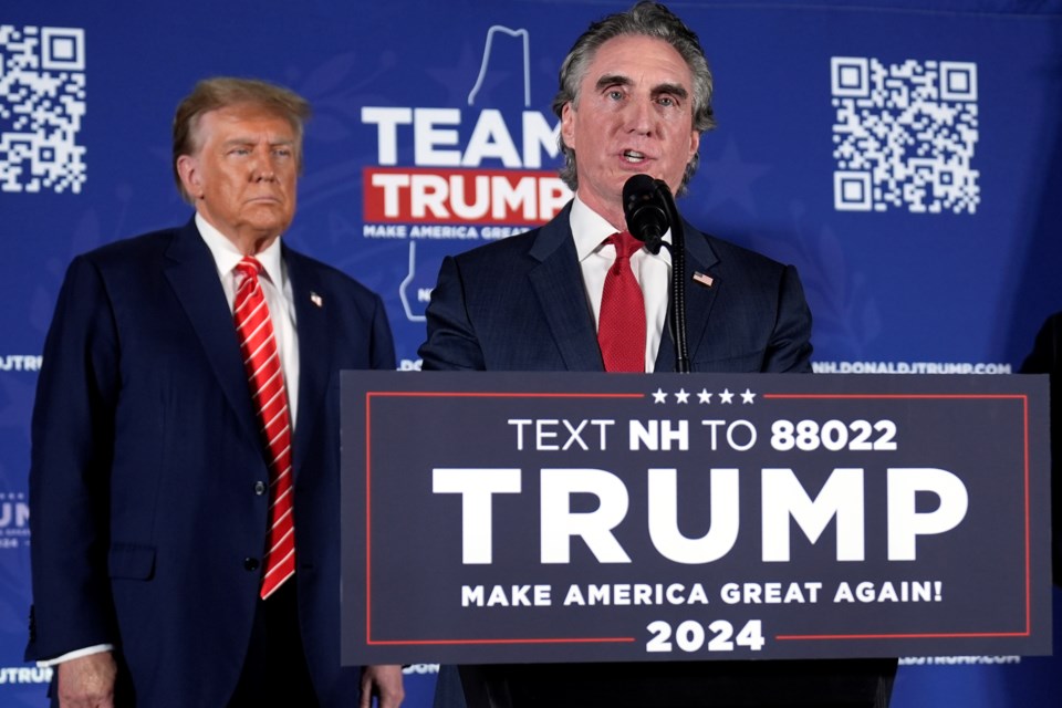 FILE - Republican presidential candidate former President Donald Trump listens as former Republican presidential candidate, North Dakota Gov. Doug Burgum, speaks on stage during a campaign event in Laconia, N.H., Jan. 22, 2024. (AP Photo/Matt Rourke, File)