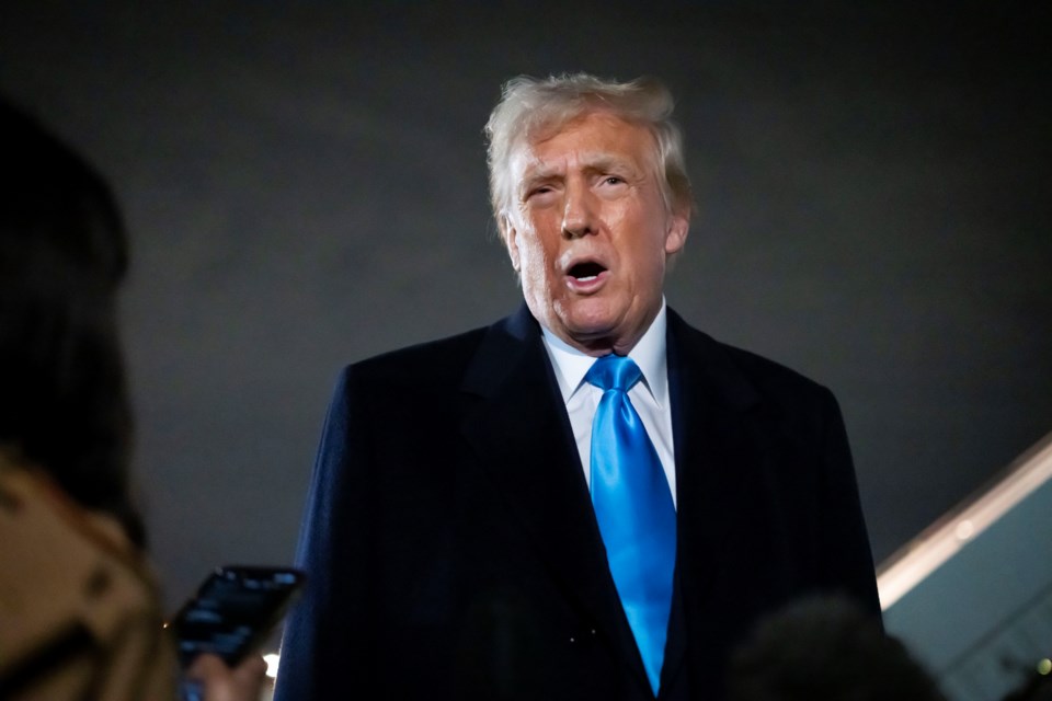 President Donald Trump speaks to reporters next to Air Force One after arriving back at Joint Base Andrews, Md., Sunday, Feb. 2, 2025. (AP Photo/Ben Curtis)