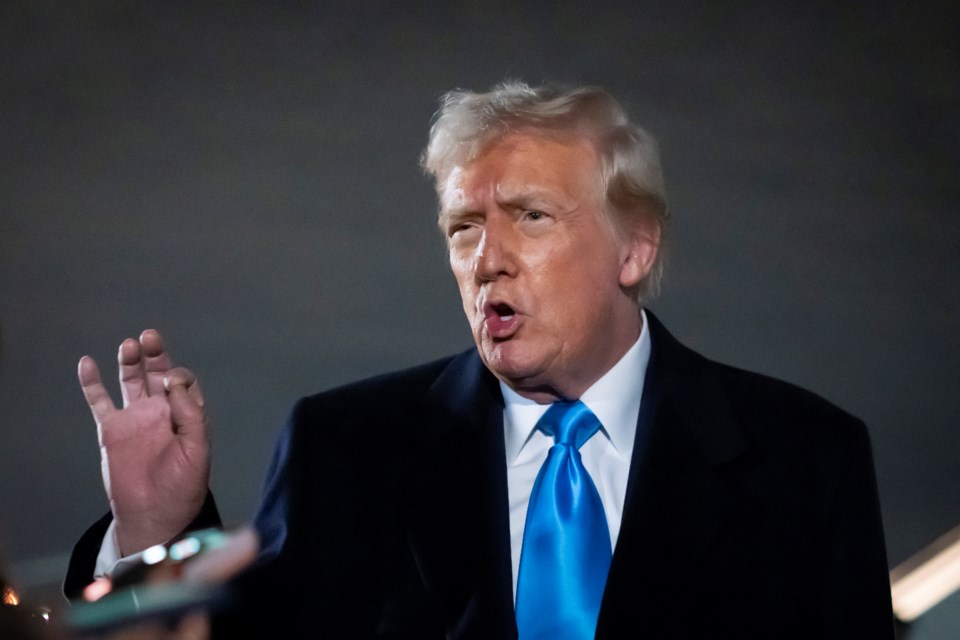 President Donald Trump speaks to reporters next to Air Force One after arriving back at Joint Base Andrews, Md., Sunday, Feb. 2, 2025. (AP Photo/Ben Curtis)