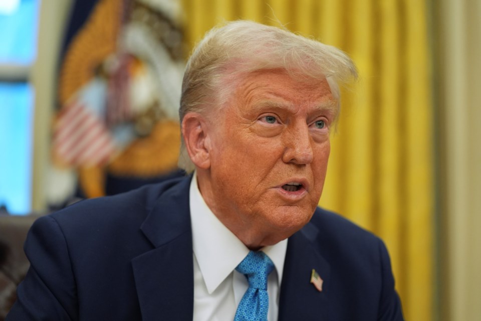 President Donald Trump speaks to reporters as he signs executive orders in the Oval Office of the White House, Friday, Jan. 31, 2025, in Washington. (AP Photo/Evan Vucci)