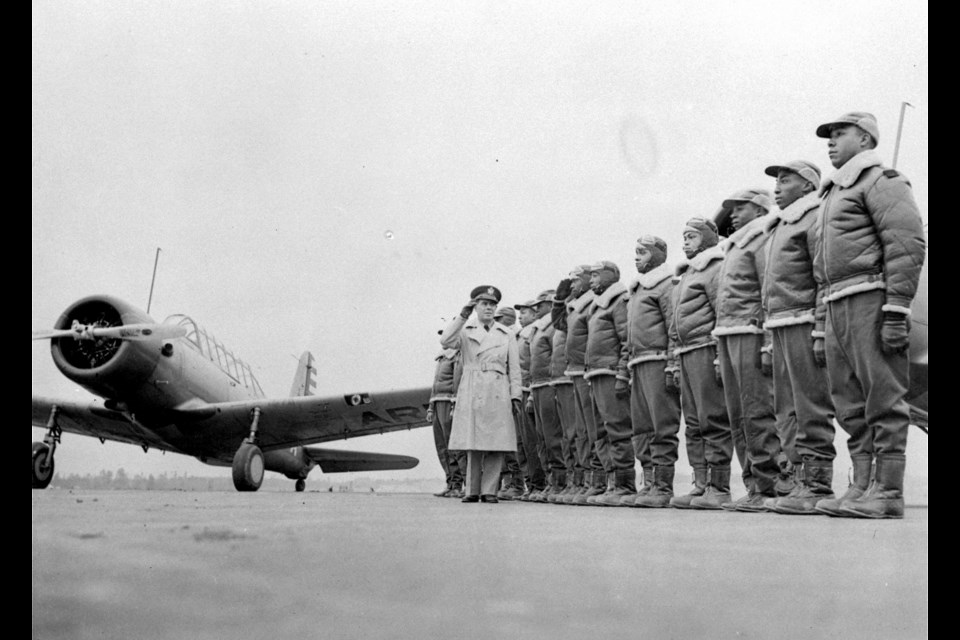 Cadets at the Basic and Advanced Flying School for Negro Air Corps Cadets are shown, Jan. 23, 1942, lined up for review with Major James A. Ellison, who is returning the salute of Mac Ross of Dayton, Ohio, as he inspects the cadets. (AP Photo/U.S. Army Signal Corps)