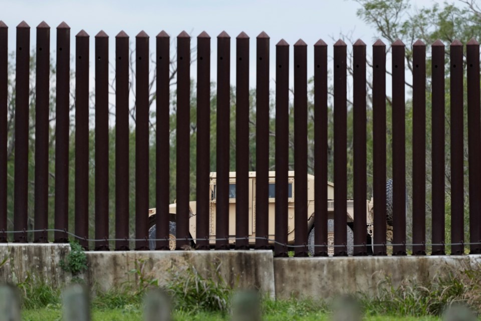 A member of the National Guard patrols along a stretch of border wall, Tuesday, Jan. 21, 2025, in Brownsville, Texas. (AP Photo/Eric Gay)