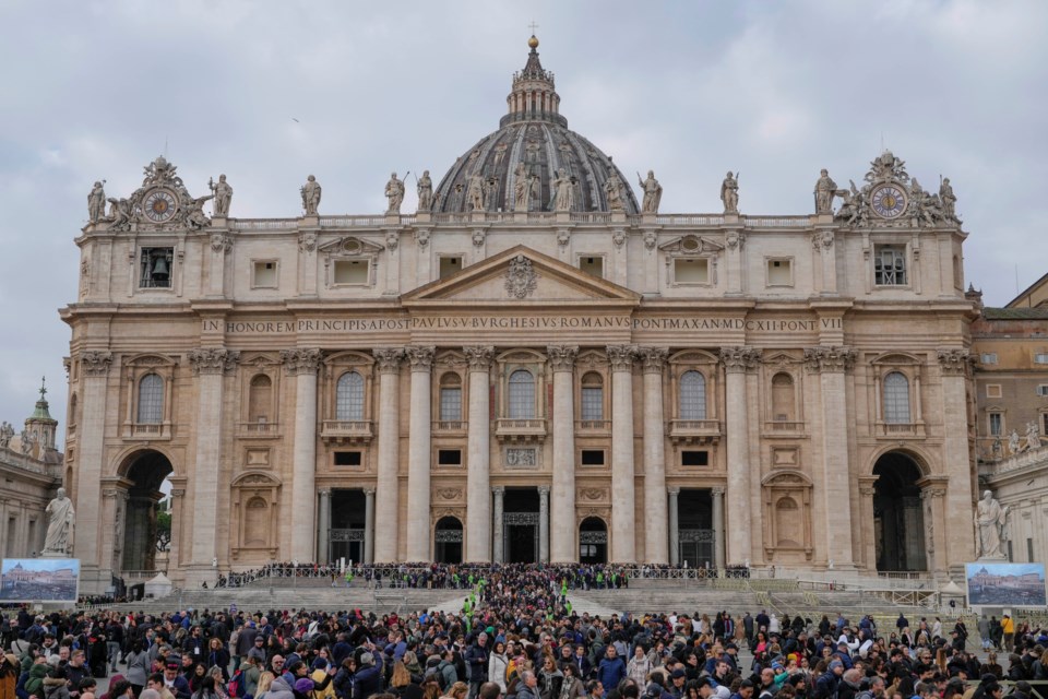 Faithful leave St. Peter's Basilica at the end of a mass presided by Pope Francis at the Vatican, Sunday, Jan. 26, 2025. (AP Photo/Gregorio Borgia)