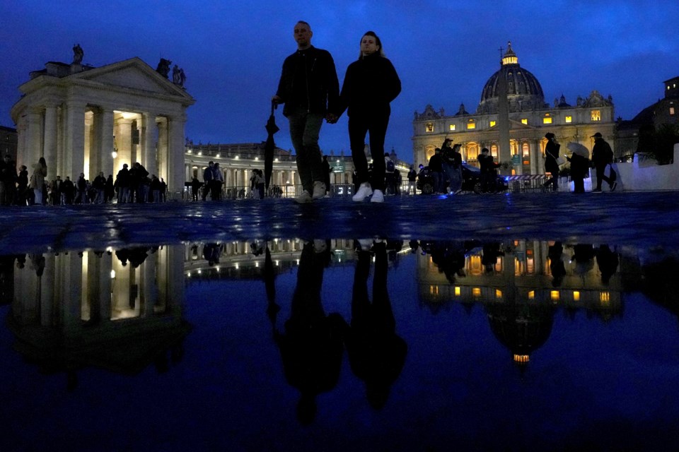 People walk outside St. Peter's Square at The Vatican, Monday, Feb. 24, 2025. (AP Photo/Kirsty Wigglesworth)