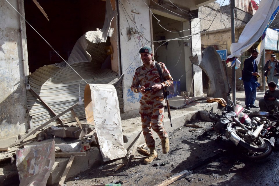 A security official checks the site of a bomb blast in Quetta, Pakistan, Friday, Feb. 28, 2025. (AP Photo/Arshad Butt)