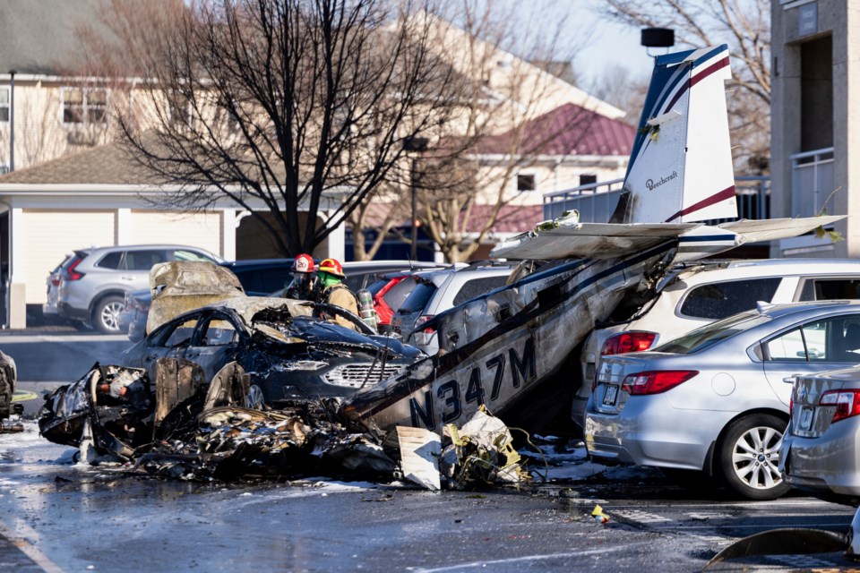 First responders work the scene after a plane crashed in the parking lot of a retirement community in Manheim Township, Pa., Sunday, March 9, 2025. (Logan Gehman/LNP/LancasterOnline via AP)