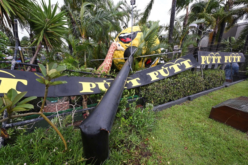 A giant golf ball sign is seen fallen outside a mini golf complex at Mermaid Beach on the Gold Coast, Australia, Saturday, March 8, 2025. (Dave Hunt/AAP Image via AP)