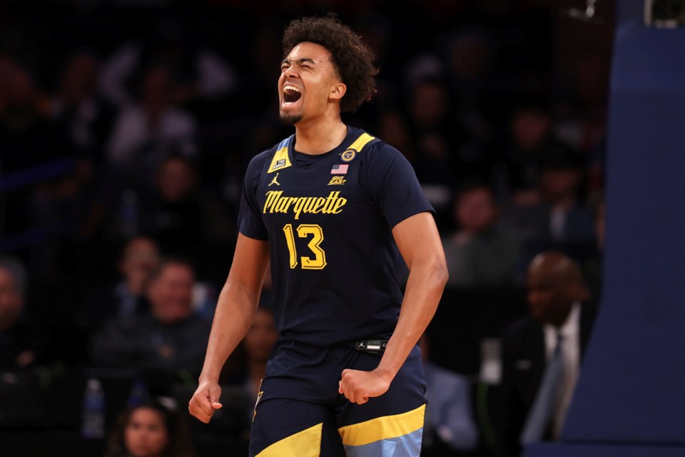 Marquette forward Royce Parham (13) reacts after dunking the ball during the first half of an NCAA college basketball game against Xavier in the quarterfinals of the Big East Conference tournament, Thursday, March 13, 2025, in New York. (AP Photo/Pamela Smith)