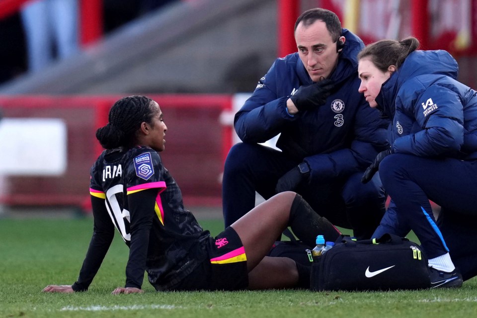 Chelsea's Naomi Girma receives treatment before being substituted during the Barclays Women's Super League match at the Broadfield Stadium, Brighton and Hove, England, Sunday, March 2, 2025. (John Walton/PA via AP)