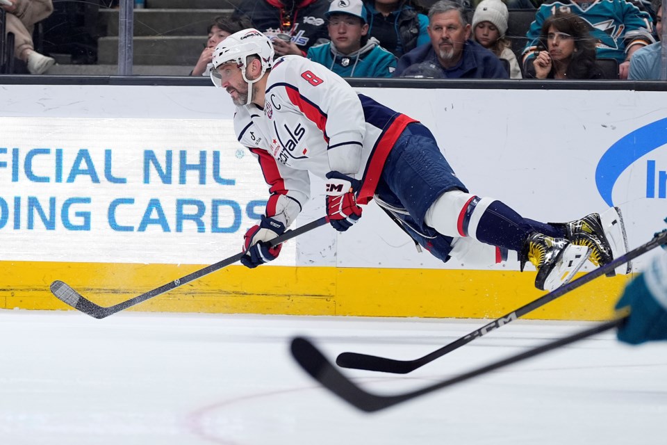 Washington Capitals left wing Alex Ovechkin dives for the puck during the second period against the San Jose Sharks in an NHL hockey game in San Jose, Calif., Saturday, March 15, 2025. (AP Photo/Tony Avelar)